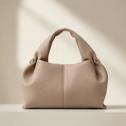 Beige handbag on a light beige background with 'Dufalo TM' branding.