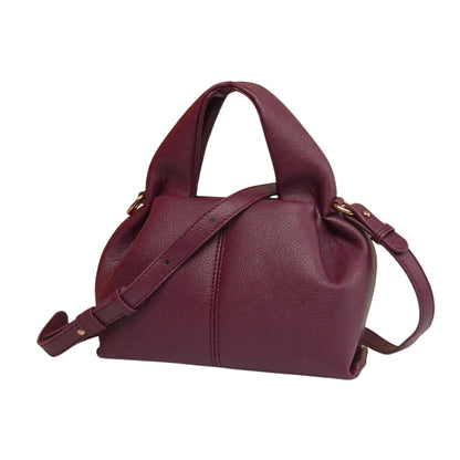 Maroon handbag with a shoulder strap on a white background
